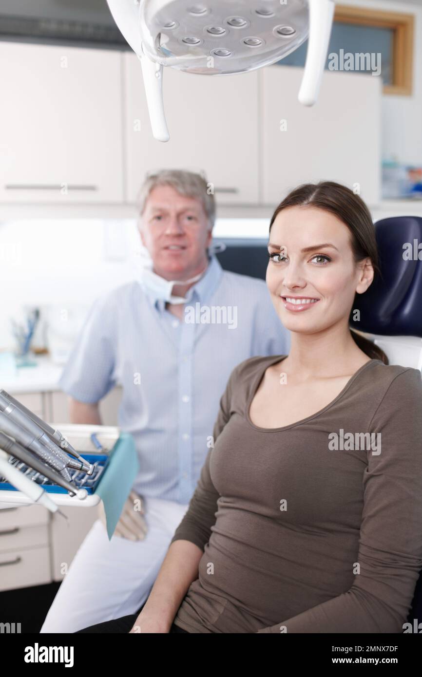 Paziente sorridente con dentista. Ritratto di una donna sorridente con dentista in clinica. Foto Stock