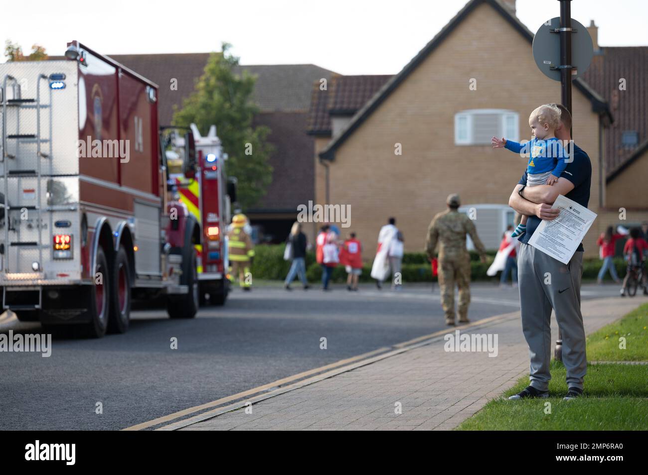 Un bambino salta alla parata annuale della settimana della prevenzione degli incendi mentre passa alla RAF Lakenheath, Inghilterra, 10 ottobre 2022. La settimana di prevenzione degli incendi è stata avviata dopo il grande incendio di Chicago nel 1922 come modo per richiamare l'attenzione sulla sicurezza antincendio. 48th Civil Engineer Squadron, 48th Fighter Wing, Fire Prevention Week, Foto Stock