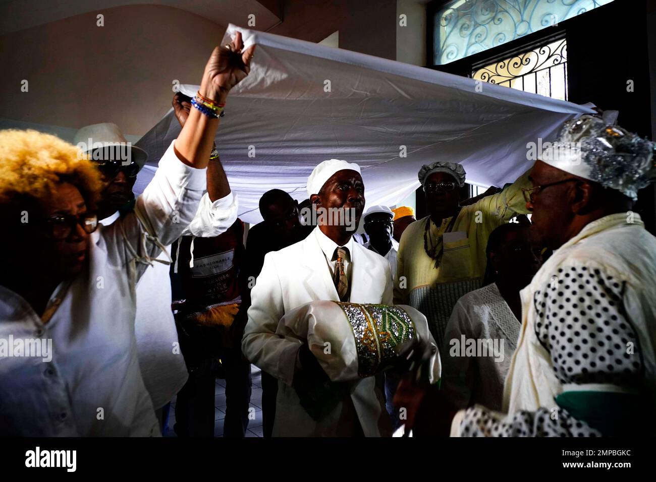 Santeria followers perform a holy drum beat after reading the annual