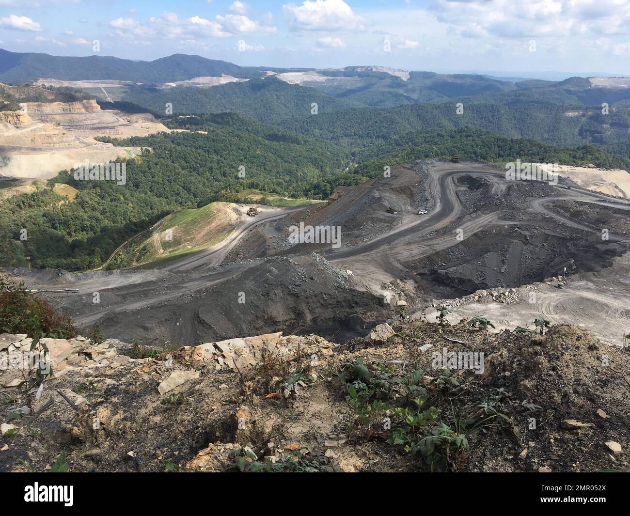 In this Tuesday, Sept. 26, 2017 photo, coal trucks and heavy equipment ...