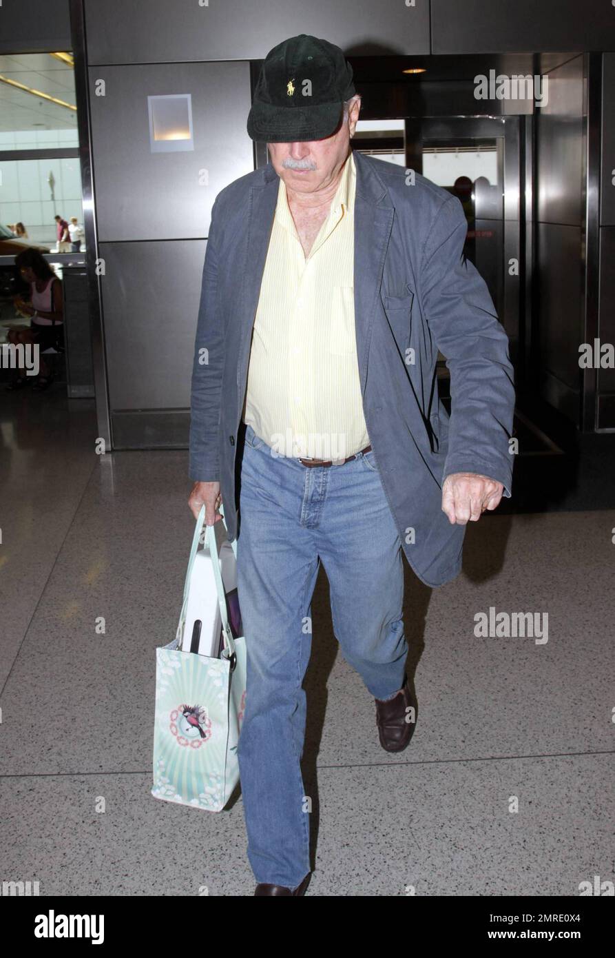 ESCLUSIVO!! Il leggendario attore, scrittore e comico britannico John Cleese, famoso per le apparizioni e la scrittura di serie televisive e film tra cui 'Monty Python's Flying Circus', 'Fawlty Towers, 'Shrek' e 'Will & Grace', arriva all'aeroporto internazionale di Miami per prendere un volo. Cleese si assicurò di portare fuori dai bagagli quello che sembrava essere un nuovo computer portatile Apple, riponendolo in una borsa a mano. Miami, Florida. 3/10/11. Foto Stock