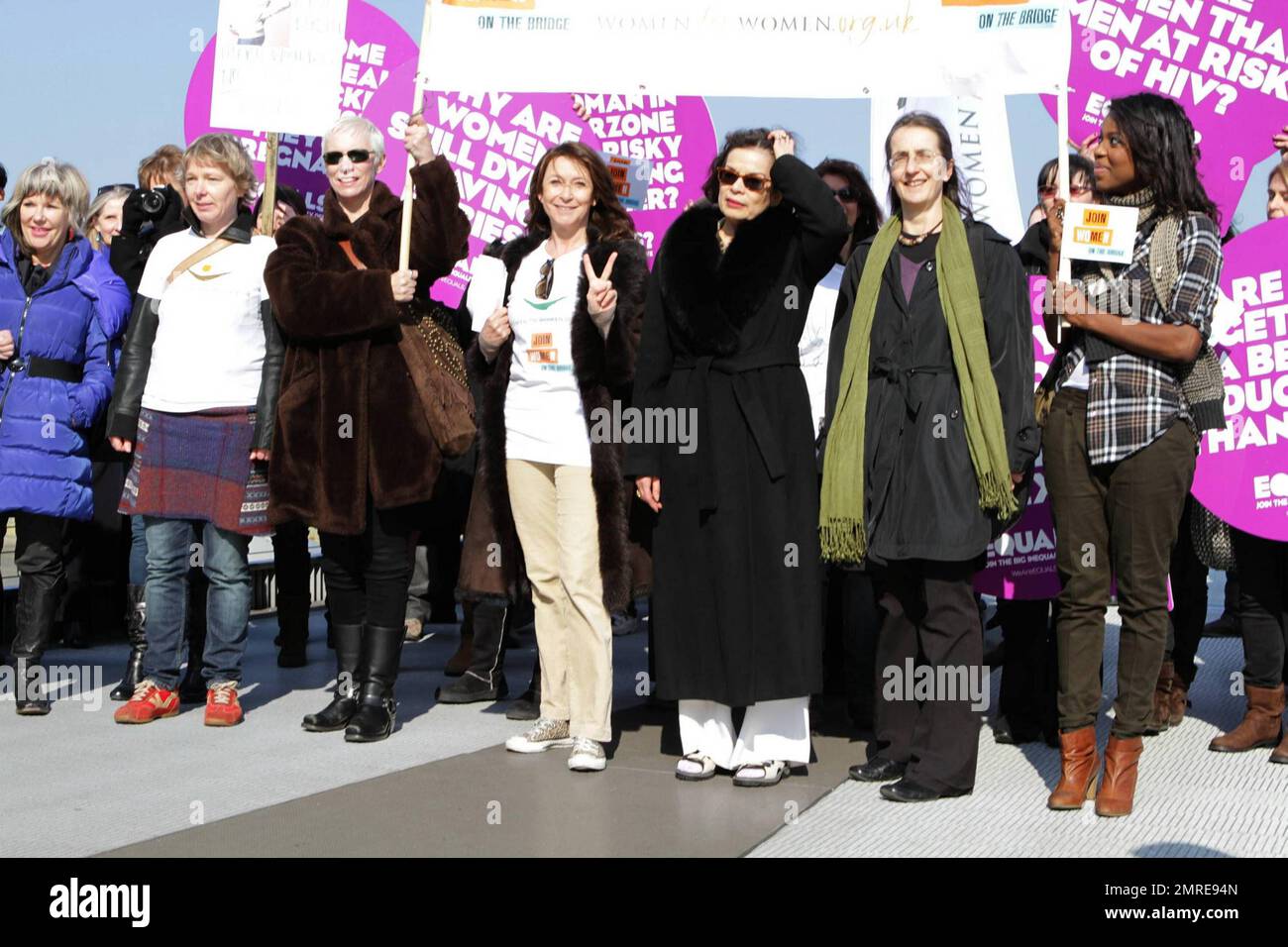 Jude Kelly, Annie Lennox, Cheri lunghi, Bianca Jagger e Dr. Helen Pankhurst camminano fianco a fianco con altre donne che portano segni sul Millennium Bridge durante la seconda campagna annuale 'Unisciti a me sul ponte' dove le colombe bianche sono state rilasciate durante la Giornata Internazionale delle Donne. Tra le donne c'era il Dr. Helen Pankhurst che ha detto: 'Sono onorato di partecipare alla campagna Unisciti a me sul ponte, in piedi forte con le donne di tutto il mondo nel chiedere l'uguaglianza tra i sessi, Come ha fatto la mia bisnonna 100 anni fa," riferendosi a Emmeline Pankhurst, attivista politico inglese e leader del gruppo B. Foto Stock