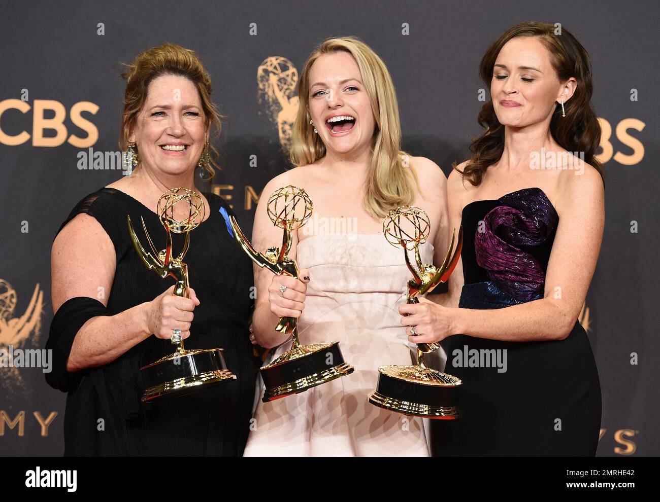 Ann Dowd, from left, winner of outstanding supporting actress in a drama series, Elisabeth Moss, winner of outstanding lead actress in a drama series, and Alexis Bledel, winner of outstanding guest actress in a drama for "The Handmaid's Tale" pose in the press room at the 69th Primetime Emmy Awards on Sunday, Sept. 17, 2017, at the Microsoft Theater in Los Angeles. (Photo by Jordan Strauss/Invision/AP) Foto Stock