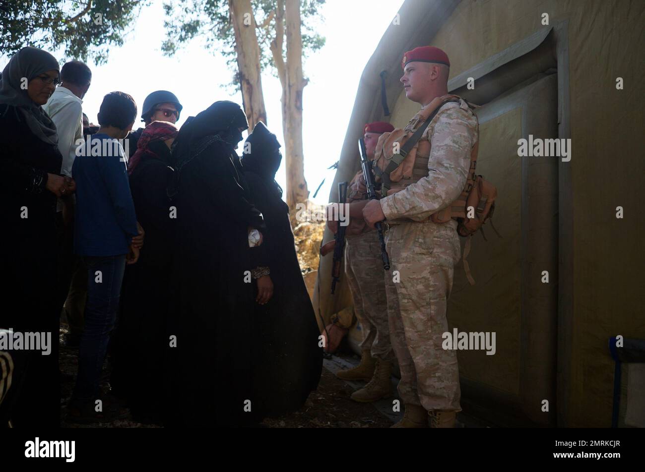In this Wednesday, Sept. 13, 2017 photo local residents queue as ...