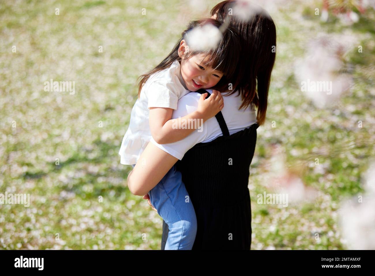 Bambino e madre giapponese in un parco cittadino Foto Stock