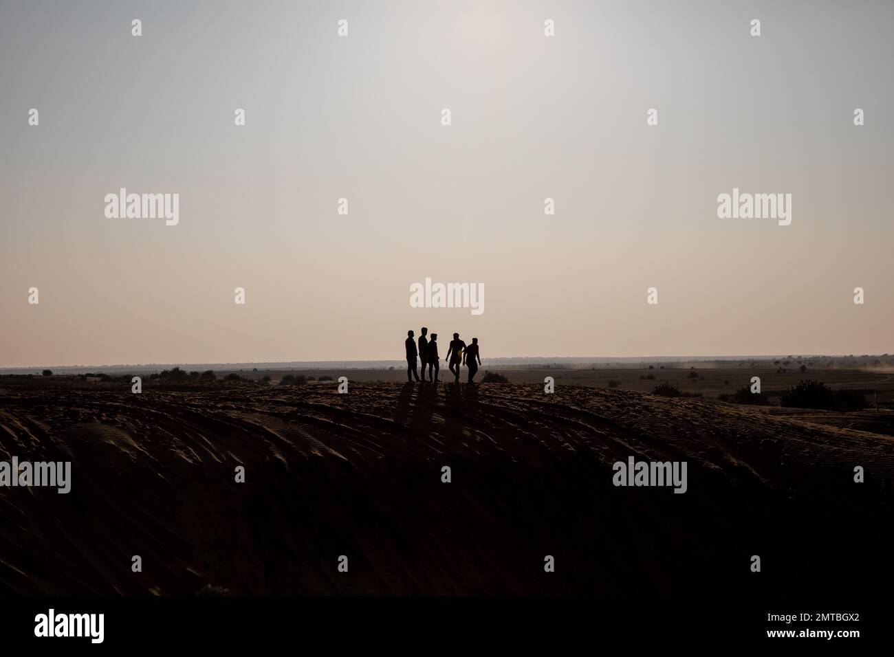 Silhouettes di un gruppo di persone nel deserto a Jaisalmer, Rajasthan, India. Foto Stock