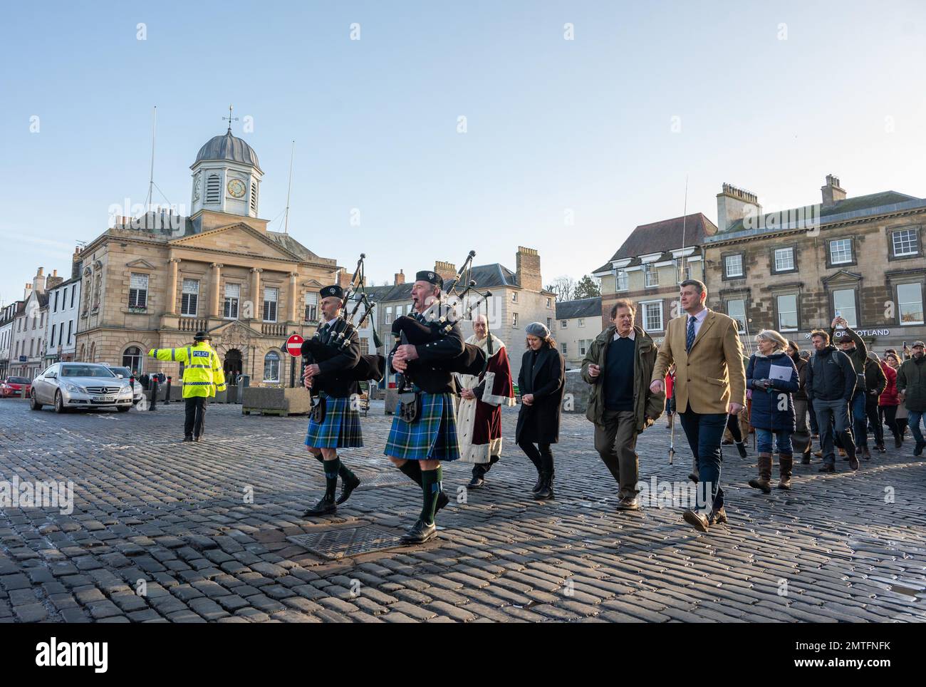 Kelso, River Tweed, Scottish Borders, Scotland, UK. Apertura ufficiale della stagione di pesca del salmone del fiume Tweed 2023. Si tiene a Kelso, ai confini scozzesi. Pipers conduce una processione di pescatori alle rive del fiume Tweed attraverso le strade acciottolate di Kelso. Comunicato stampa 1 Febbraio 2023 Stagione di pesca del salmone del fiume Tweed aperta ufficialmente a Kelso la River Tweed Commission (RTC) ha ospitato oggi per oltre 30 anni la prima apertura ufficiale della stagione di pesca del salmone del fiume Tweed ai confini scozzesi. Il Tweed è famoso in tutto il mondo e ha una tradizione di pesca Foto Stock