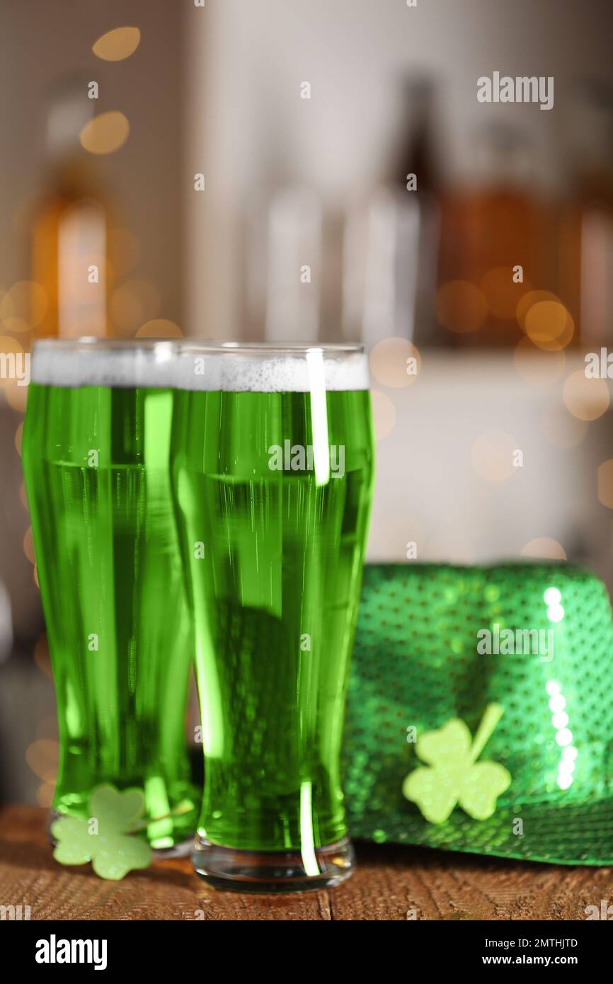 Birra verde, trifoglio e cappello sul banco di legno. Festa di San Patrizio Foto Stock