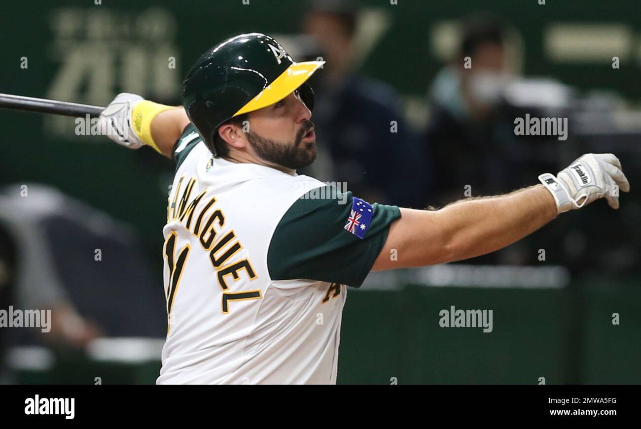 Australia's Allan de San Miguel hits a solo home-run off Japan's ...