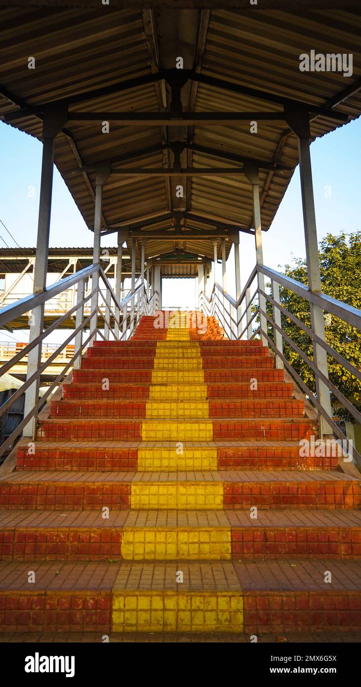 Stazione ferroviaria piede su scala va a piedi su ponte, vista interna del corridoio della stazione, scala di un piede su ponte a una stazione ferroviaria rurale stat Foto Stock