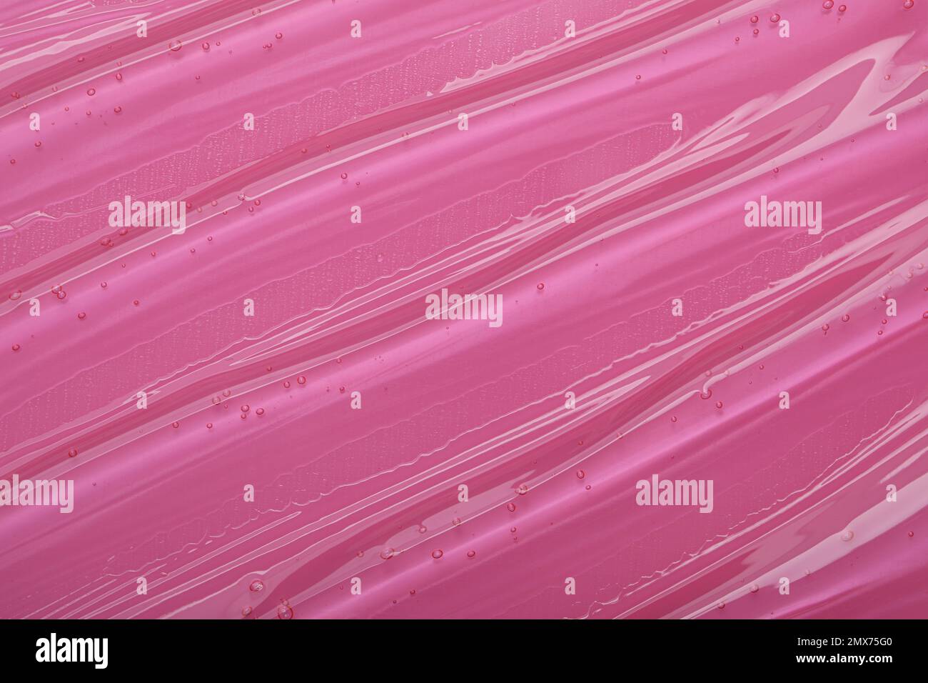 Gel cosmetico trasparente puro su sfondo rosa, primo piano Foto Stock