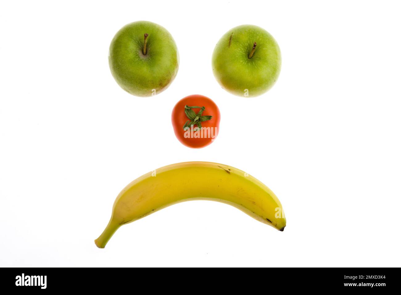 anti smiley fatto di mele, pomodoro e banana Foto Stock