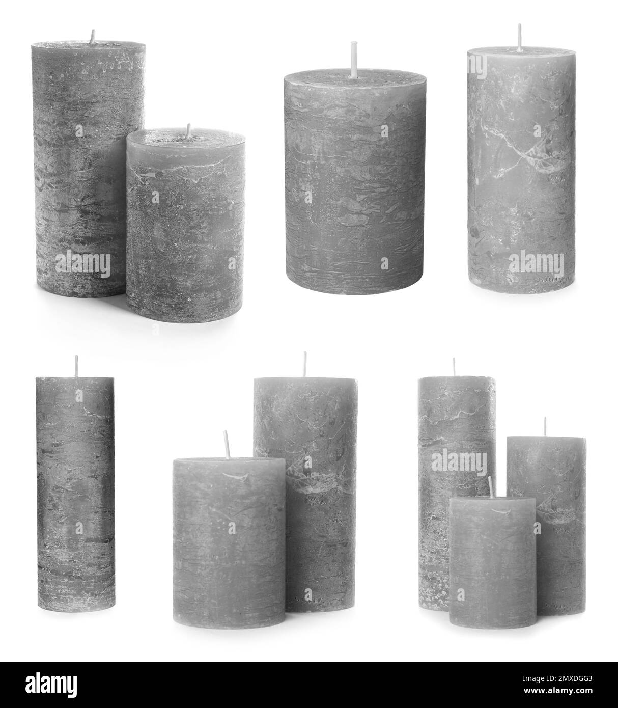 Set di candele di cera grigie su sfondo bianco Foto Stock