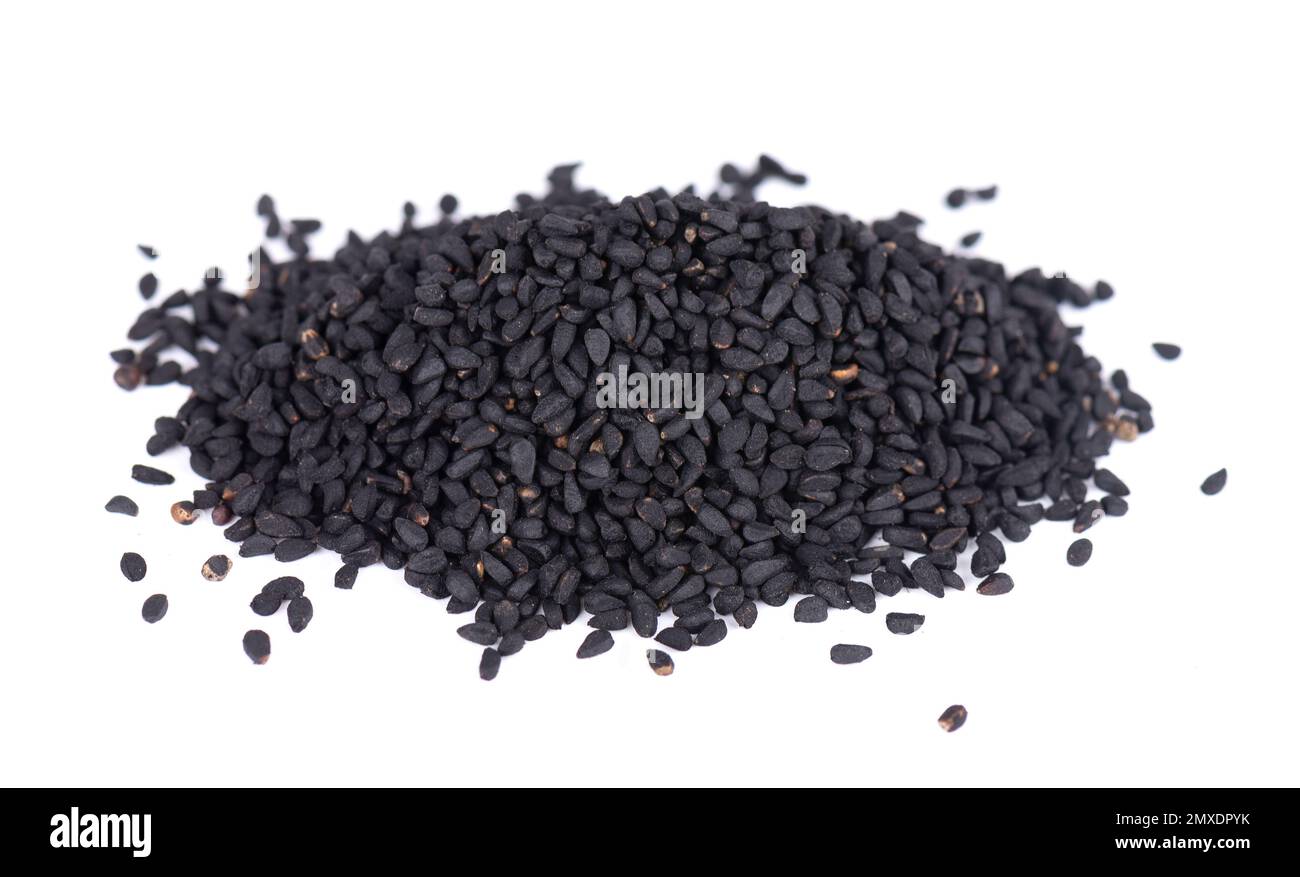 Semi di cumino nero isolati su sfondo bianco. Mucchio di semi neri di nigella. Nigella sativa Foto Stock