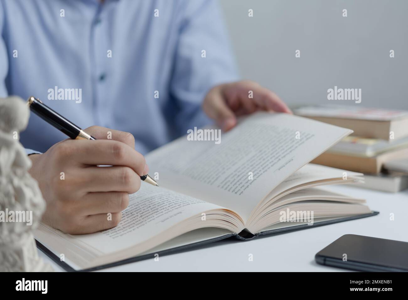 Businessperson che legge e che scrive su book.education che studia lo sviluppo di conoscenza ed il concetto imparante di cognizione. Foto Stock