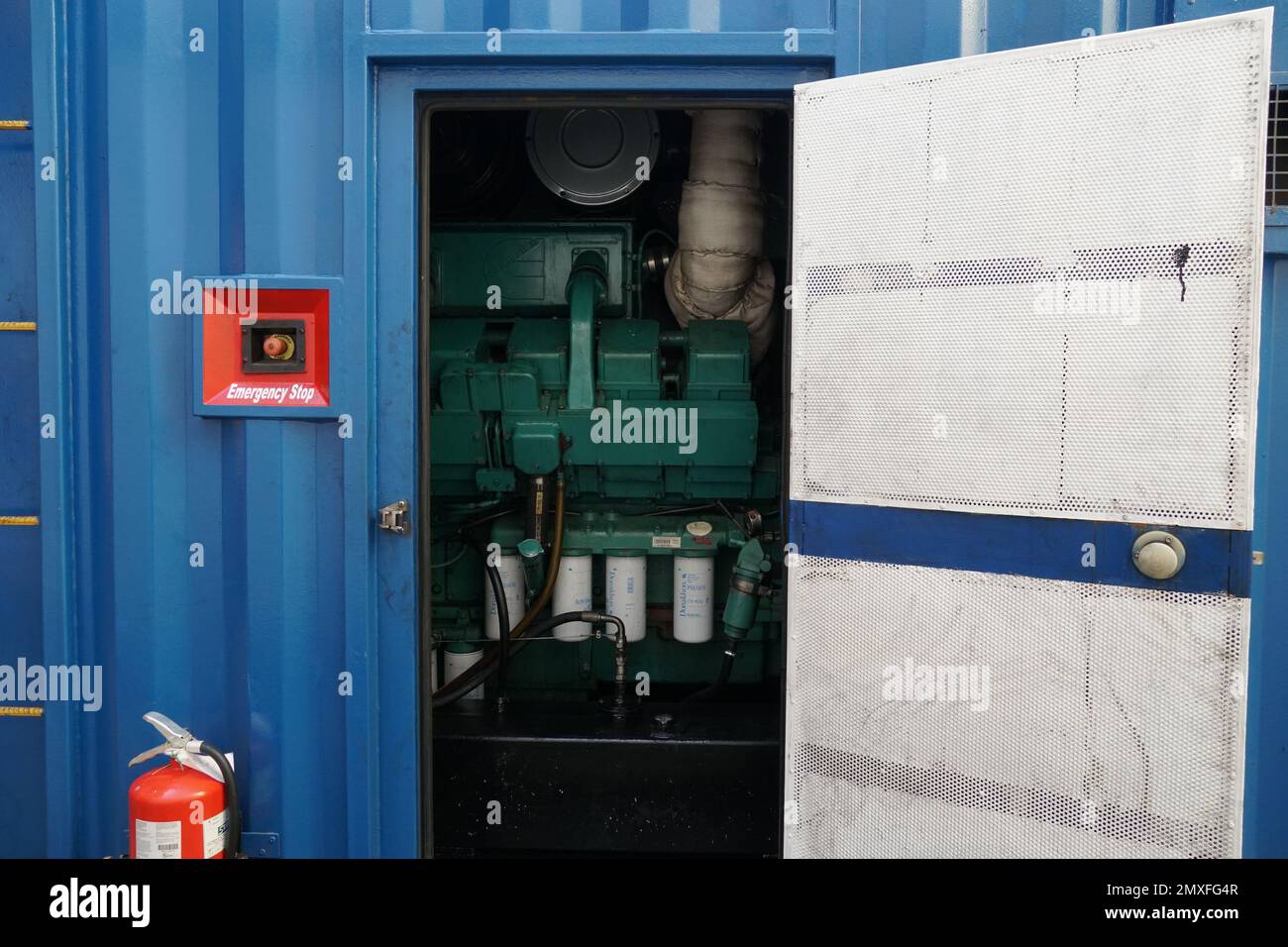 Aprire la porta del gruppo di alimentazione blu o del generatore portatile per fornire elettricità ai recipienti trasportati su un contenitore. Foto Stock