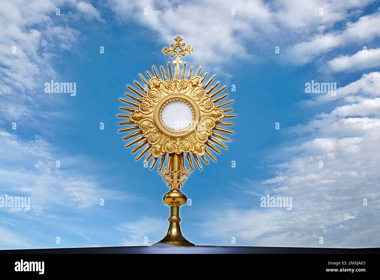 Ostrania per l'adorazione in una cerimonia della chiesa cattolica - Adorazione del Santissimo Sacramento - simbolo religioso sullo sfondo a forma di cuore blu Foto Stock