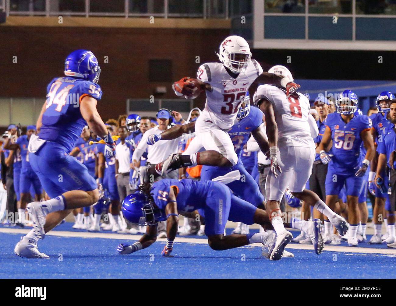 Washington State running back James Williams (32) leaps over Boise State cornerback Tyler Horton (14) during the first half of an NCAA college football game in Boise, Idaho, Saturday, Sept. 10, 2016. (AP Photo/Otto Kitsinger) Foto Stock