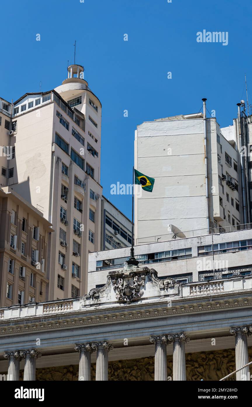 Una bandiera brasiliana issata che sventola sulla cima del palazzo Pedro Ernesto, sede della camera dei deputati del comune di Rio de Janeiro in piazza Floriano. Foto Stock