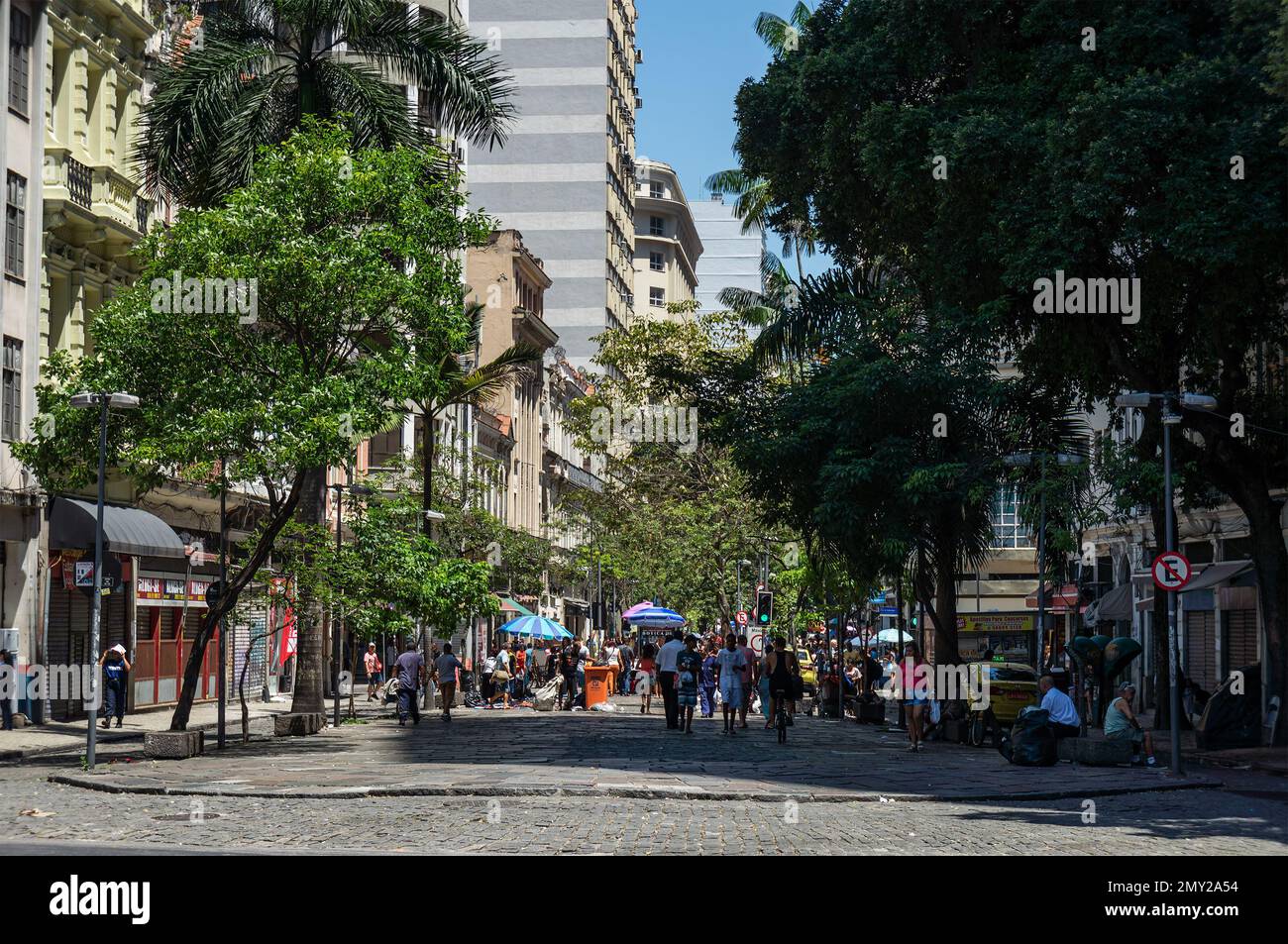 Pedoni a piedi in uruguaiana strada pedonale solo passeggiata situato nel popolato quartiere Centro sotto estate mattina cielo blu soleggiato. Foto Stock