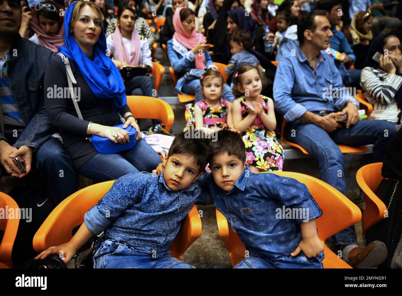 Iranian twins pose for a photo while attending a festival of Iranian twins to break Guinness's world record for the largest gathering of twins at the Azadi (Freedom) Stadium in Tehran, Iran, Thursday, May 12, 2016. Iranian twins gathered in Tehran to celebrate their 6th national festival, though they failed to break Guinness's world record for the largest gathering of the kind. (AP Photo/Vahid Salemi) Foto Stock