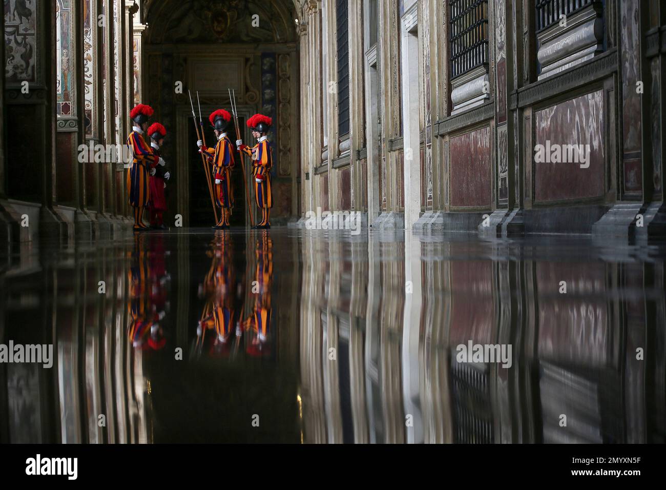 Vatican Swiss guards stand in the corridor of the entrance of the