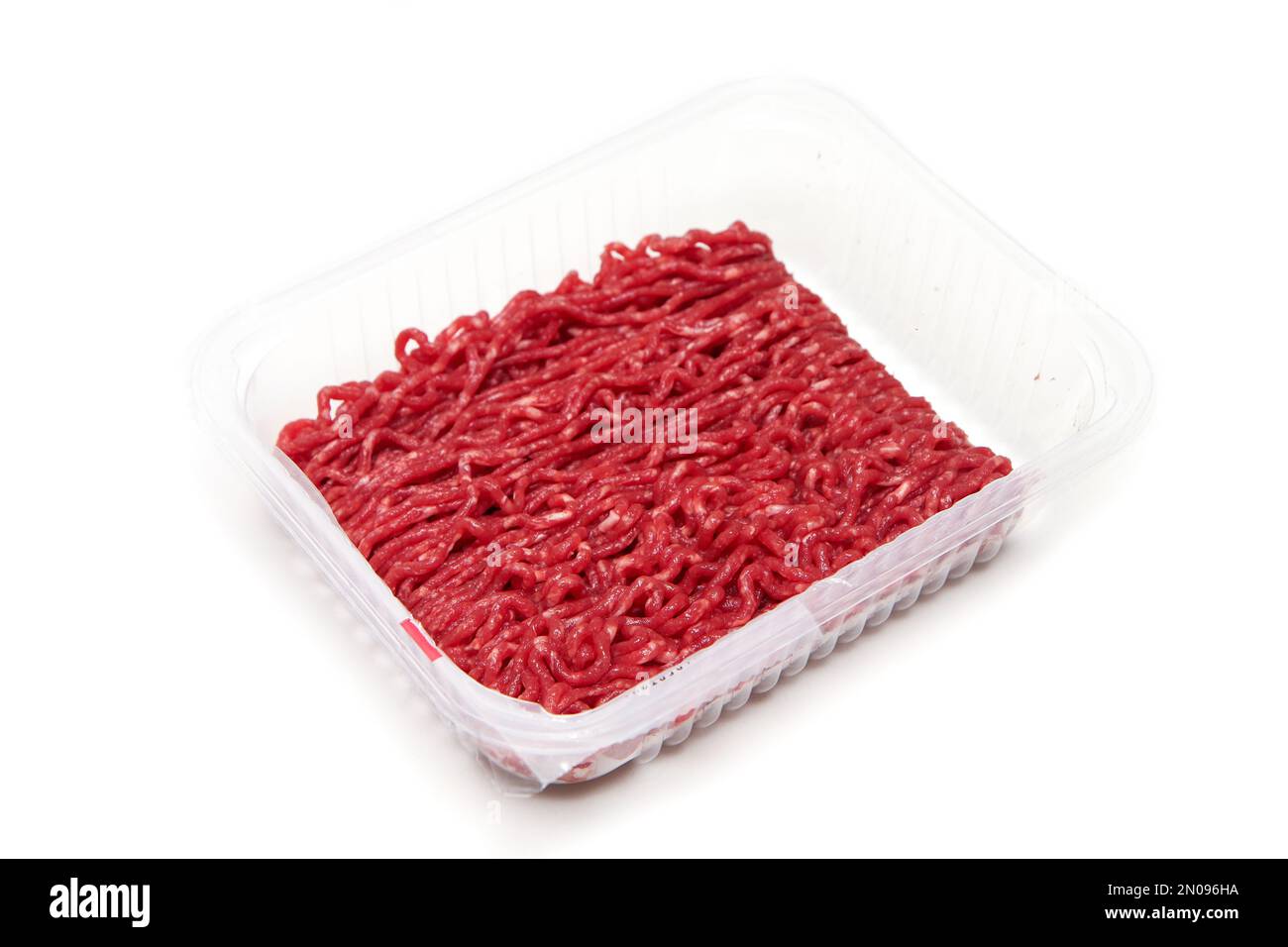 La carne di manzo cruda macinata in un particolare di vaschetta di plastica. Isolato su sfondo bianco. Foto Stock