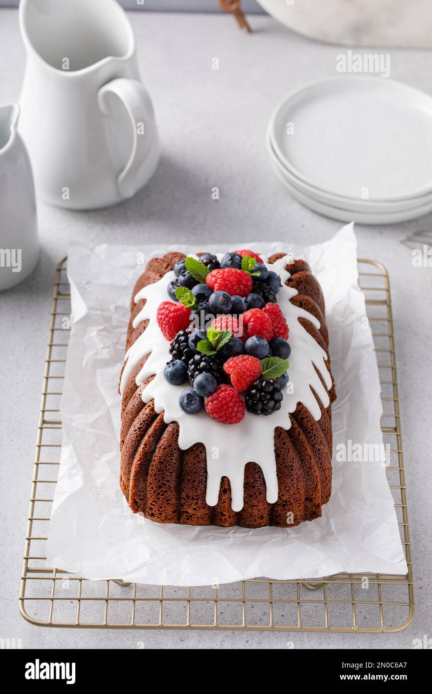 Torta al cioccolato o pane veloce con glassa di formaggio cremoso e frutti di bosco freschi Foto Stock