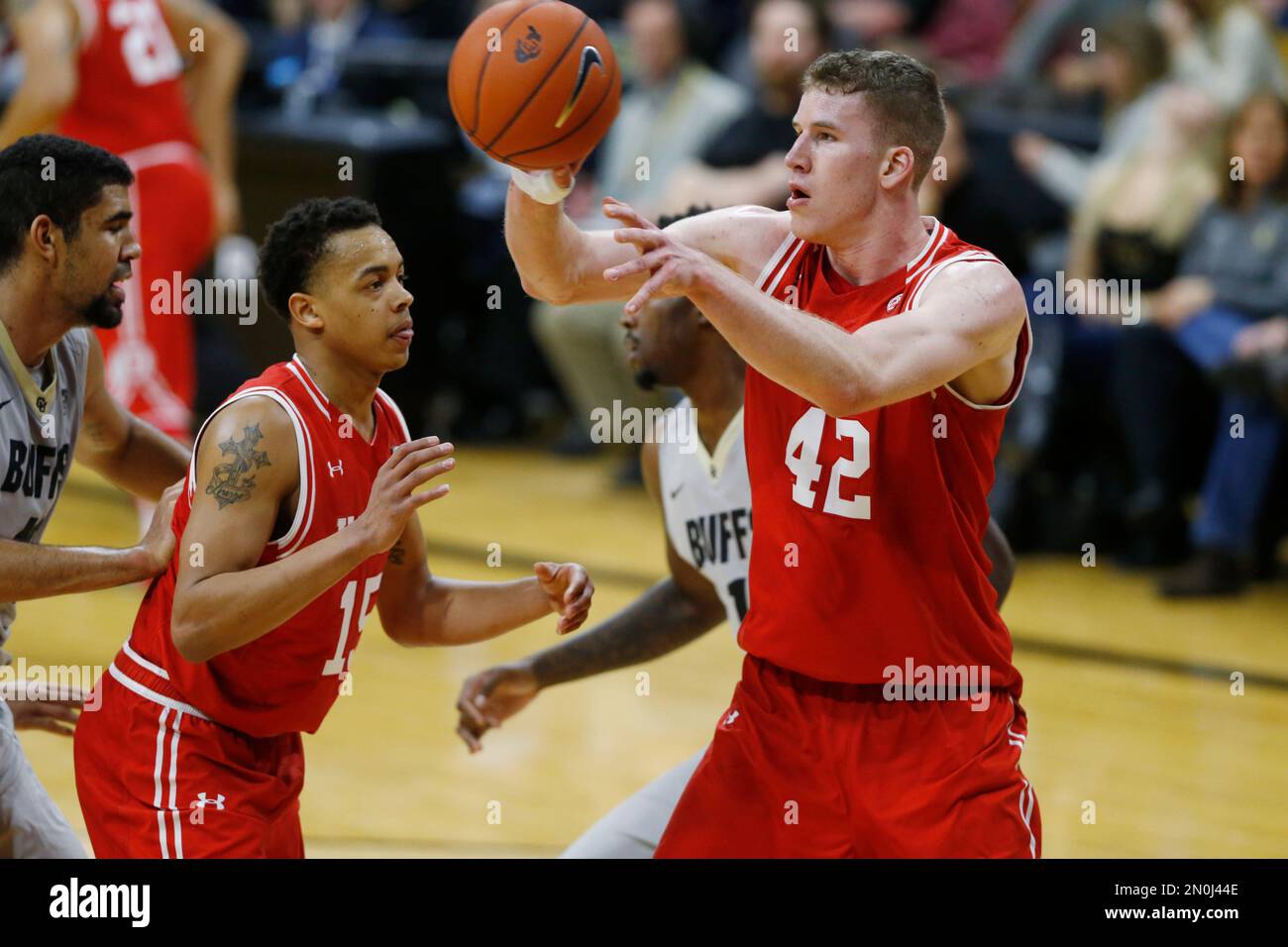 Utah forward Jakob Poeltl, front right, pulls in rebound in front of Colorado forward Wesley Gordon, back right, as Utah guard Lorenzo Bonam looks on during the second half of an NCAA college basketball game Friday, Jan. 8, 2016, in Boulder, Colo. Utah won 56-54. (AP Photo/David Zalubowski) Foto Stock
