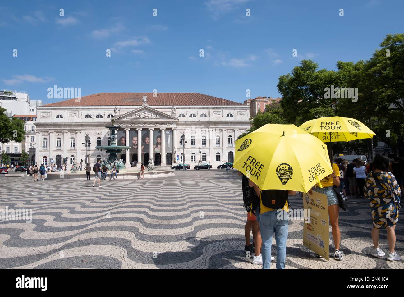 Un gruppo di guide turistiche gratuite in cerca di turisti, in Piazza Rossio a Lisbona, Portogallo, orizzontale Foto Stock