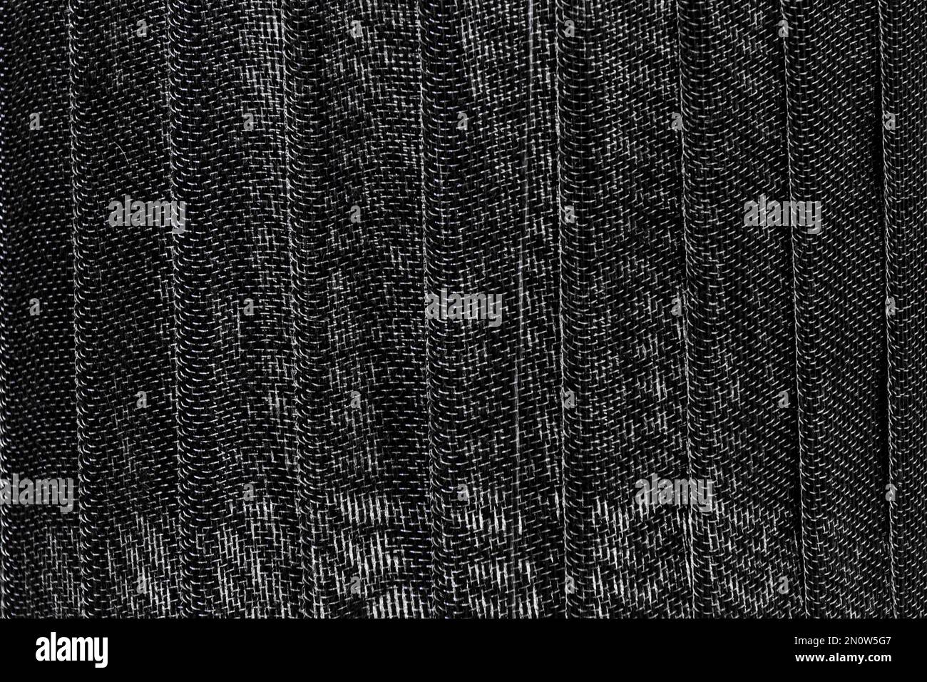 Superficie rivestita con tessuto spesso in filo nero. texture di sfondo del tessuto Foto Stock