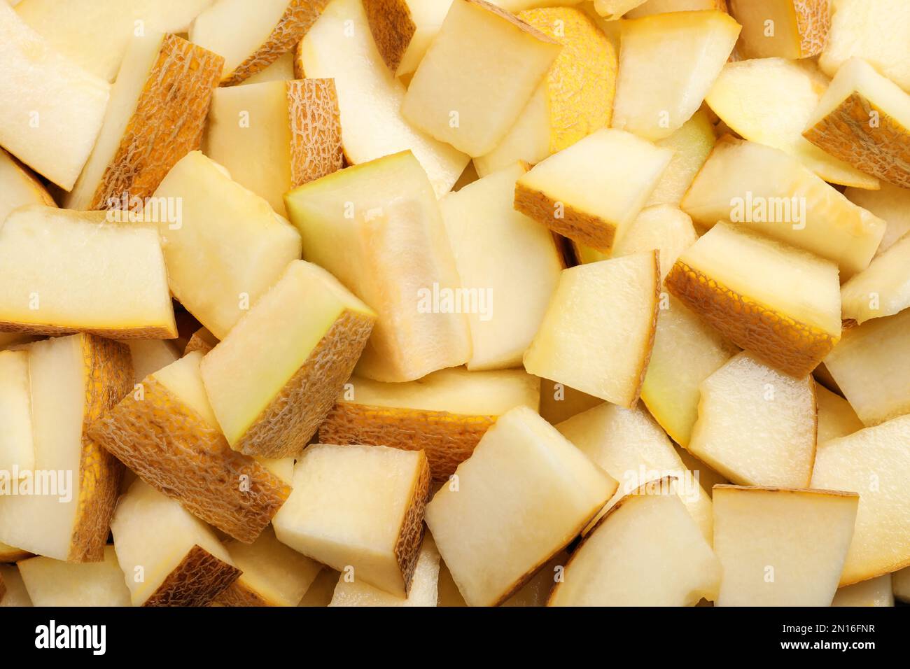 Pezzi di delizioso melone al miele come sfondo, vista dall'alto Foto Stock