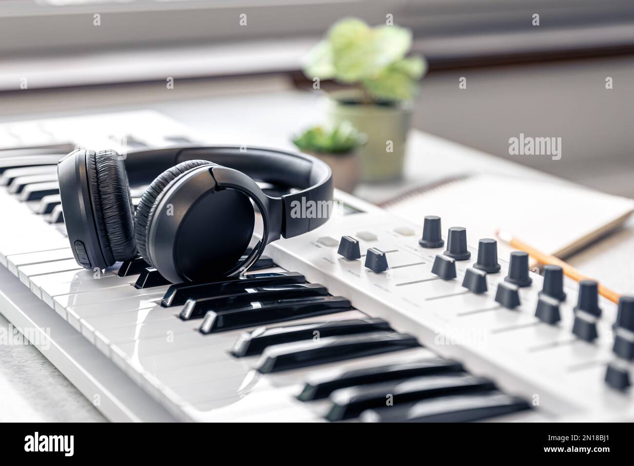 Primo piano, cuffie con tastiera midi, concetto musicale. Foto Stock