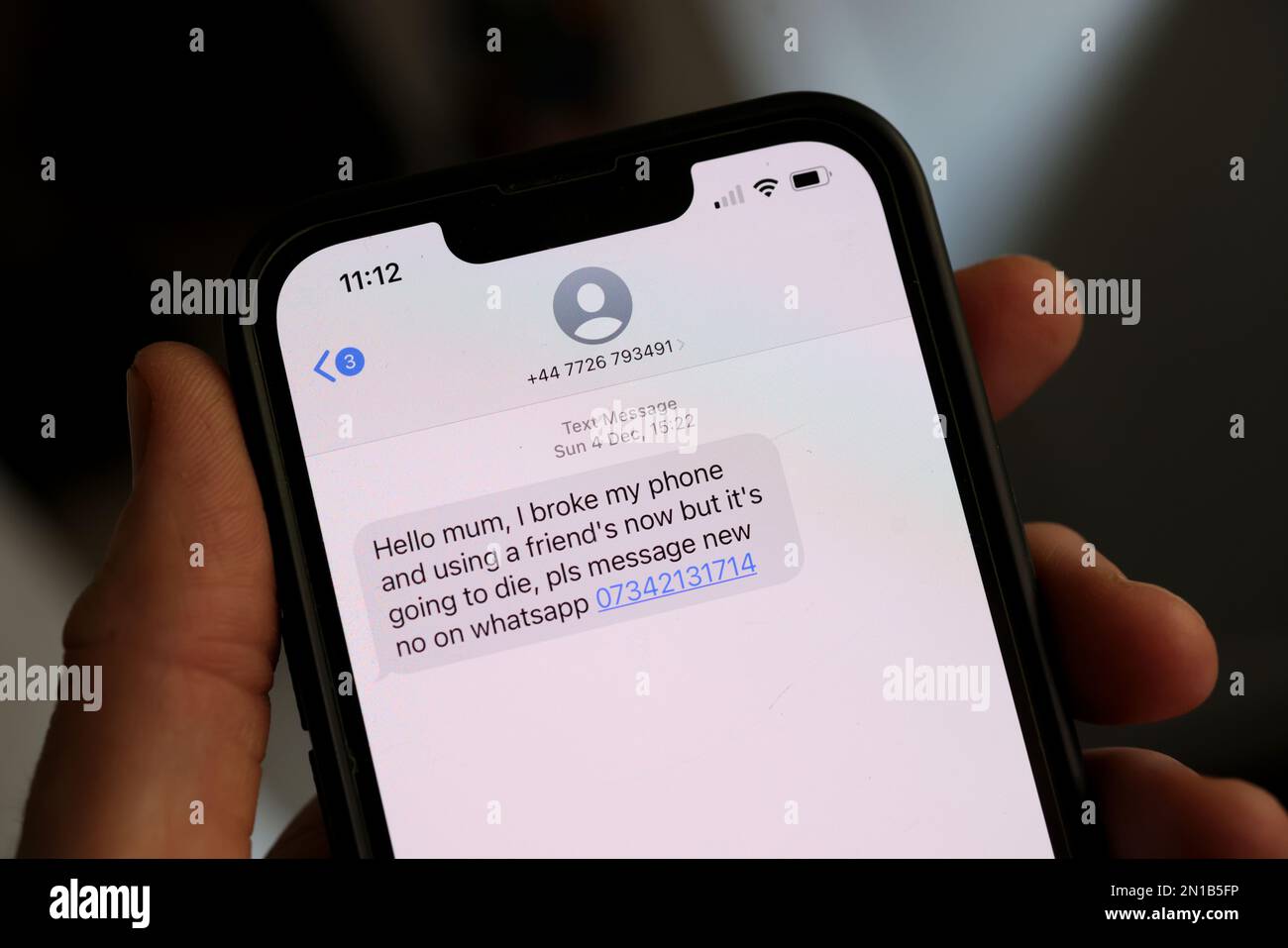 Screenshot di un messaggio di testo su un iPhone inviato da uno scammer cercando di ingannare il proprietario nel inviare SMS indietro e passare le informazioni personali. Londra, Regno Unito. Foto Stock