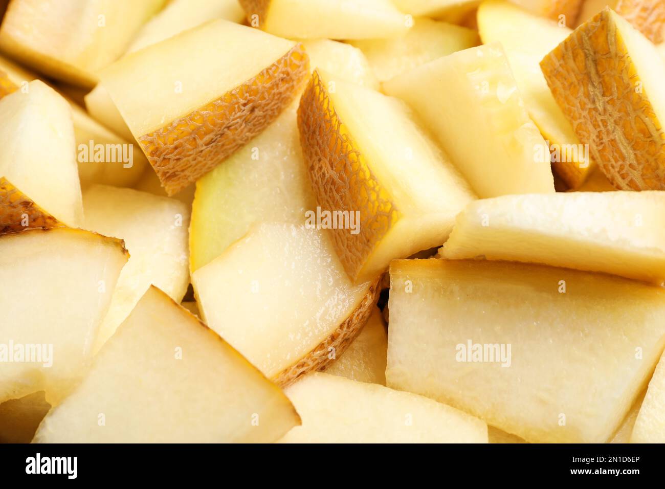 Pezzi di delizioso melone di miele come sfondo, primo piano Foto Stock