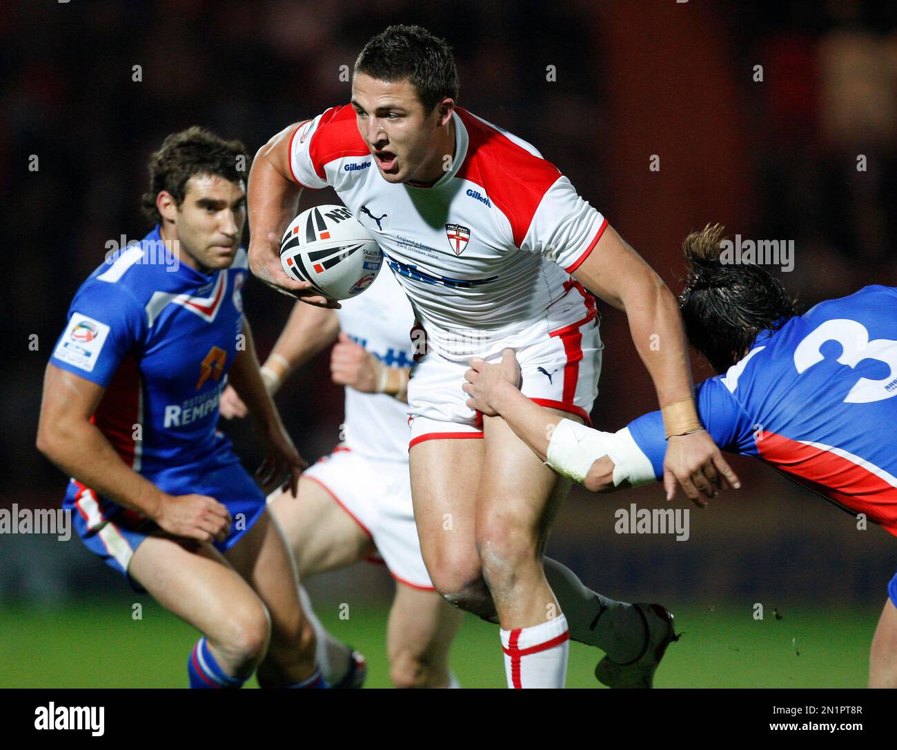 FILE- In this image dated Friday Oct. 23, 2009, England's Sam Burgess,  centre, is tackled by France's Sebastien Raguin, right, during their Four  Nations rugby league match at the Keepmoat Stadium, Doncaster,