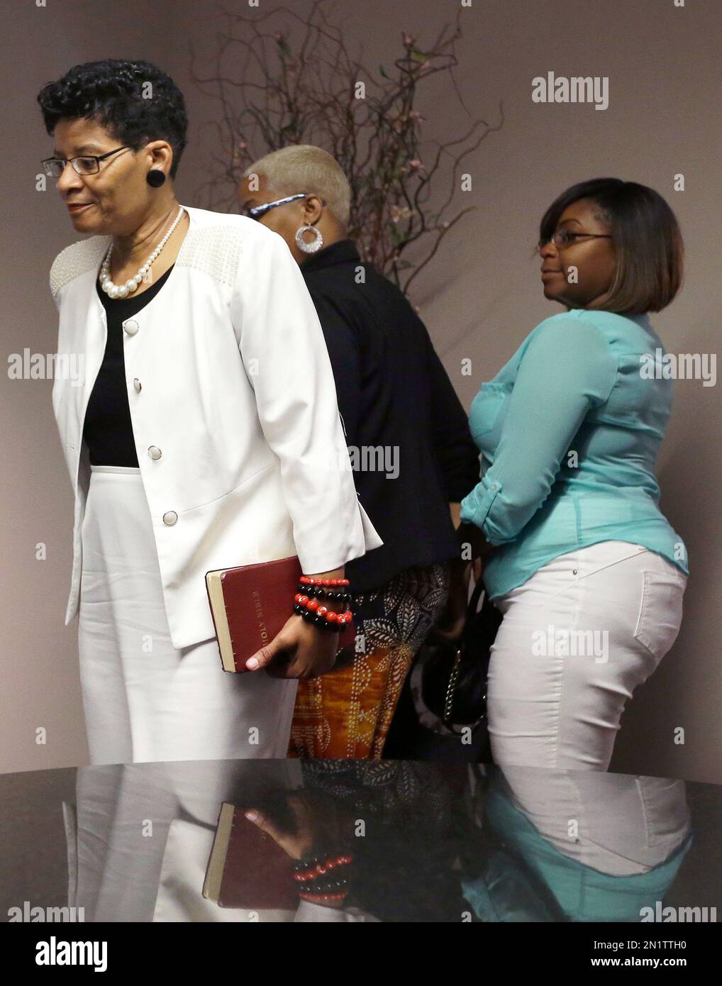 Holding a bible Geneva Reed-Veal, left, mother of Sandra Bland, and her daughters Shante Needham, center, and Sierra Cole enter news conference Tuesday, Aug. 4, 2015, in Houston. Bland's family has filed a wrongful-death lawsuit Tuesday against the officer and other officials, saying it was a last resort after being unable to get enough information about the case. Bland, a 28-year-old Chicago-area woman, was found dead in her Waller County jail cell in Hempstead, Texas on July 13. (AP Photo/Pat Sullivan) Foto Stock