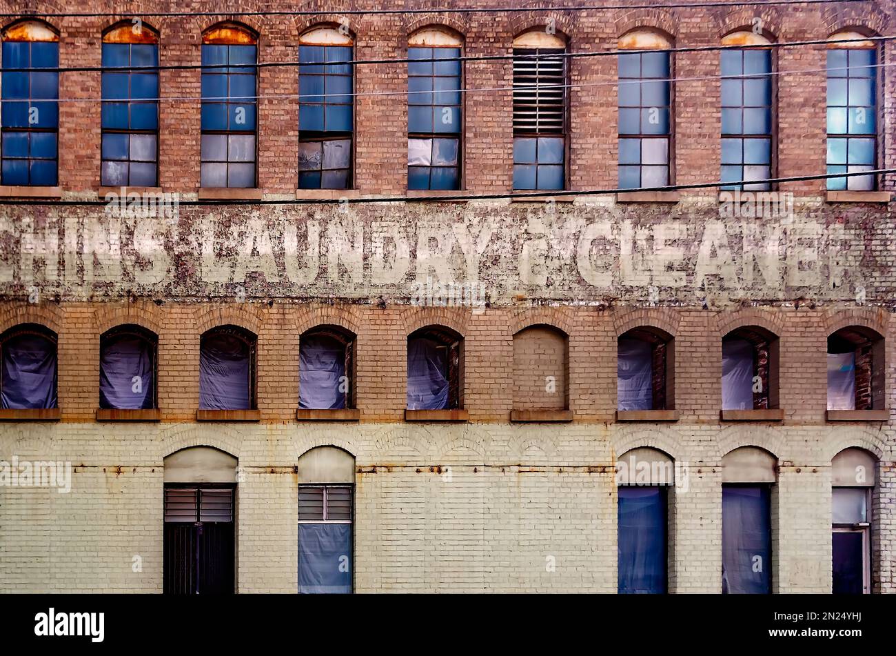 Un segno fantasma di Chin's Laundry & Cleaners è rivelato durante la ristrutturazione della proprietà su St Louis Street, 30 gennaio 2023, a Mobile, Alabama. Foto Stock