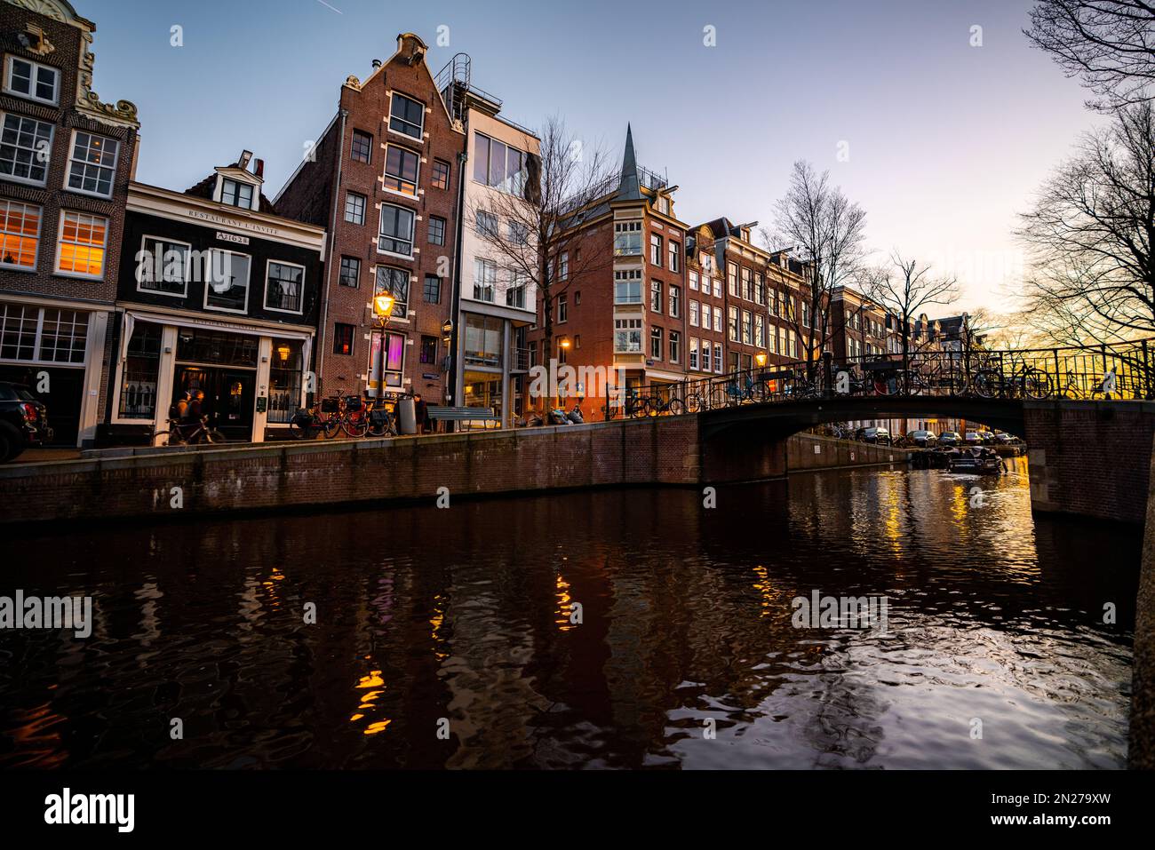 Vista sul canale di Amsterdam. Edifici storici e colorati ad Amsterdam, nei Paesi Bassi. Amsterdam al tramonto a febbraio. Foto Stock
