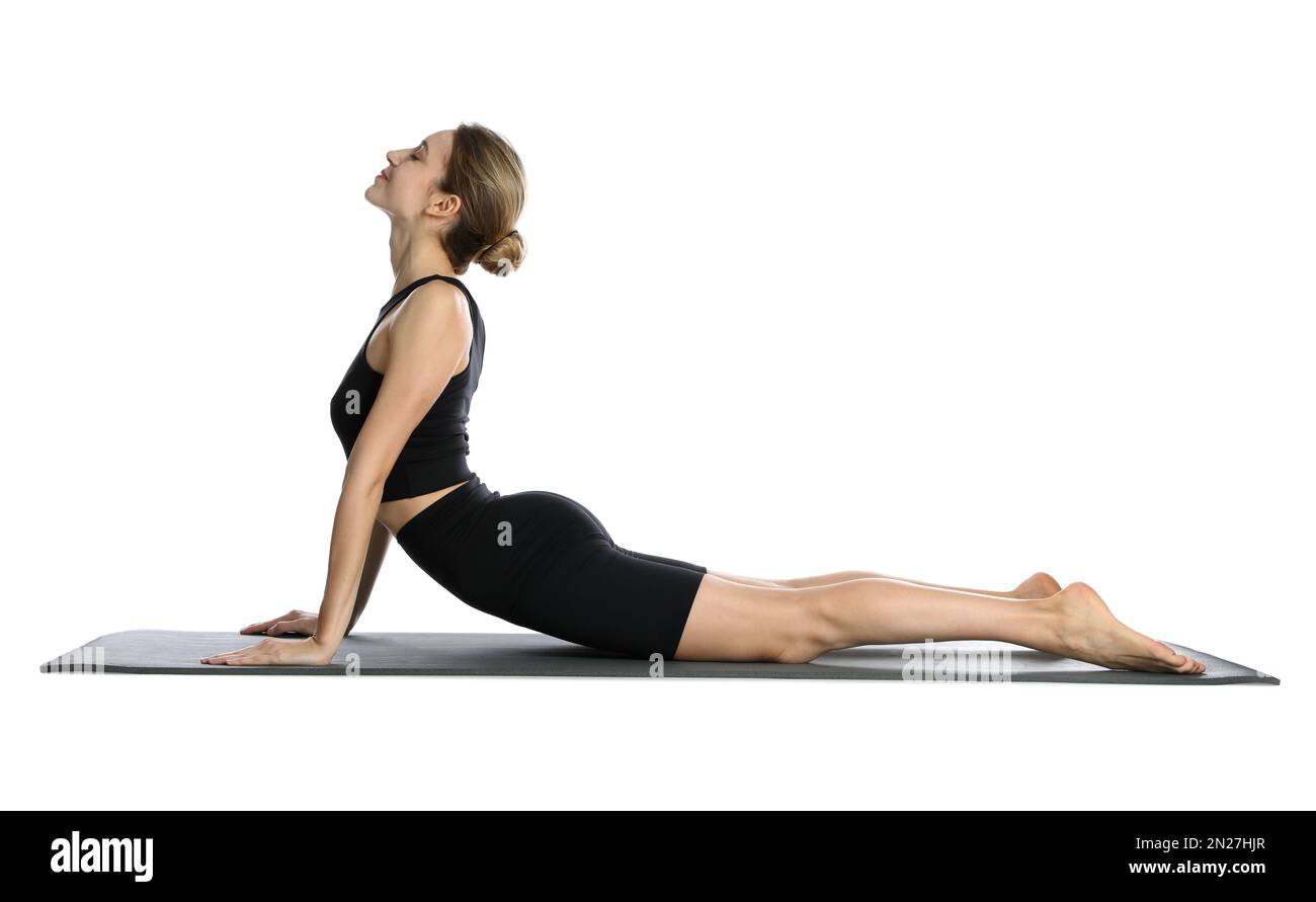 Giovane donna in abbigliamento sportivo che pratica yoga su sfondo bianco Foto Stock