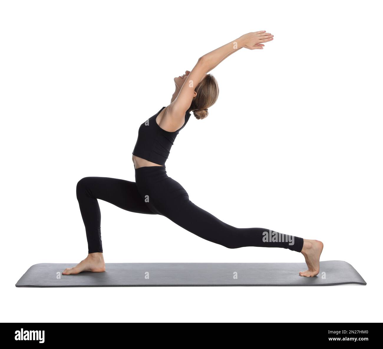 Giovane donna in abbigliamento sportivo che pratica yoga su sfondo bianco Foto Stock