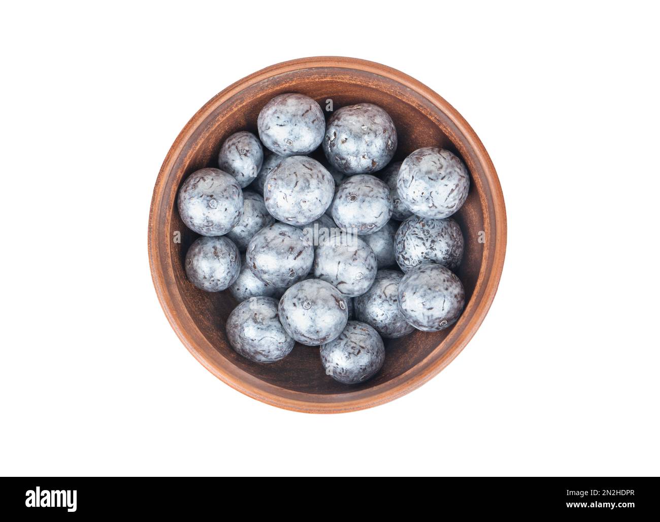 Nocciole al cioccolato in una ciotola di ceramica isolata su sfondo bianco, vista dall'alto Foto Stock