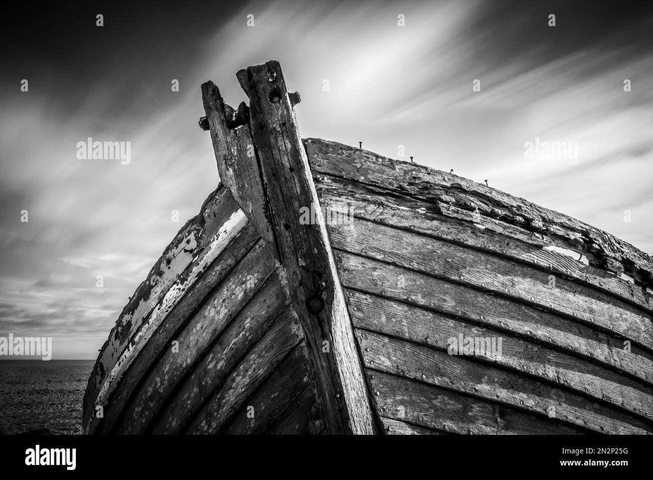 Belle vecchie barche da pesca in legno, abbandonate sulla spiaggia di scisto a Dungeness nel Kent, marciume e decadimento nel corso di decenni di mare e di erosione del tempo Foto Stock