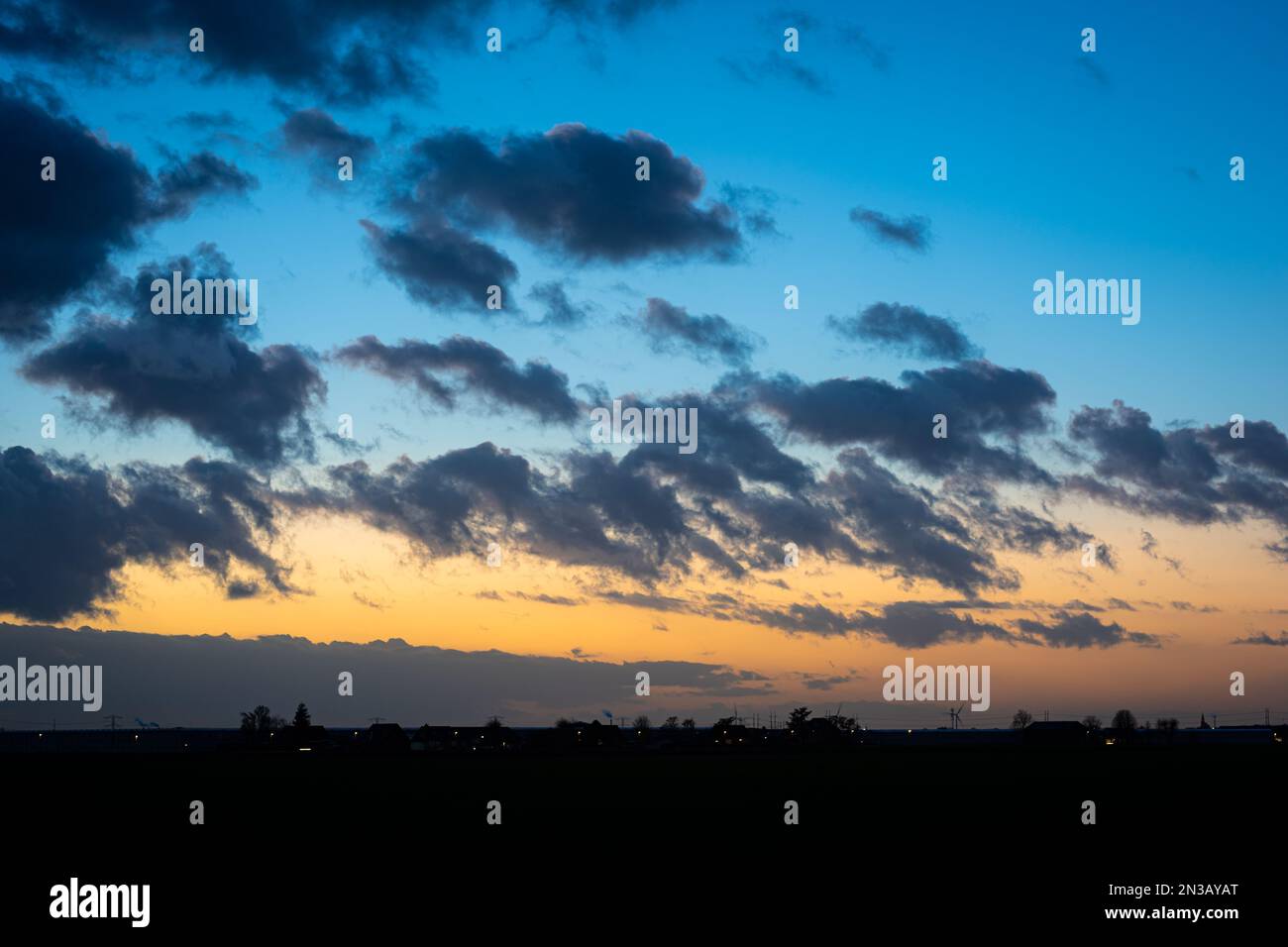 Le nuvole rapidamente drifting contrastano piacevolmente con il cielo sera crepuscolo Foto Stock