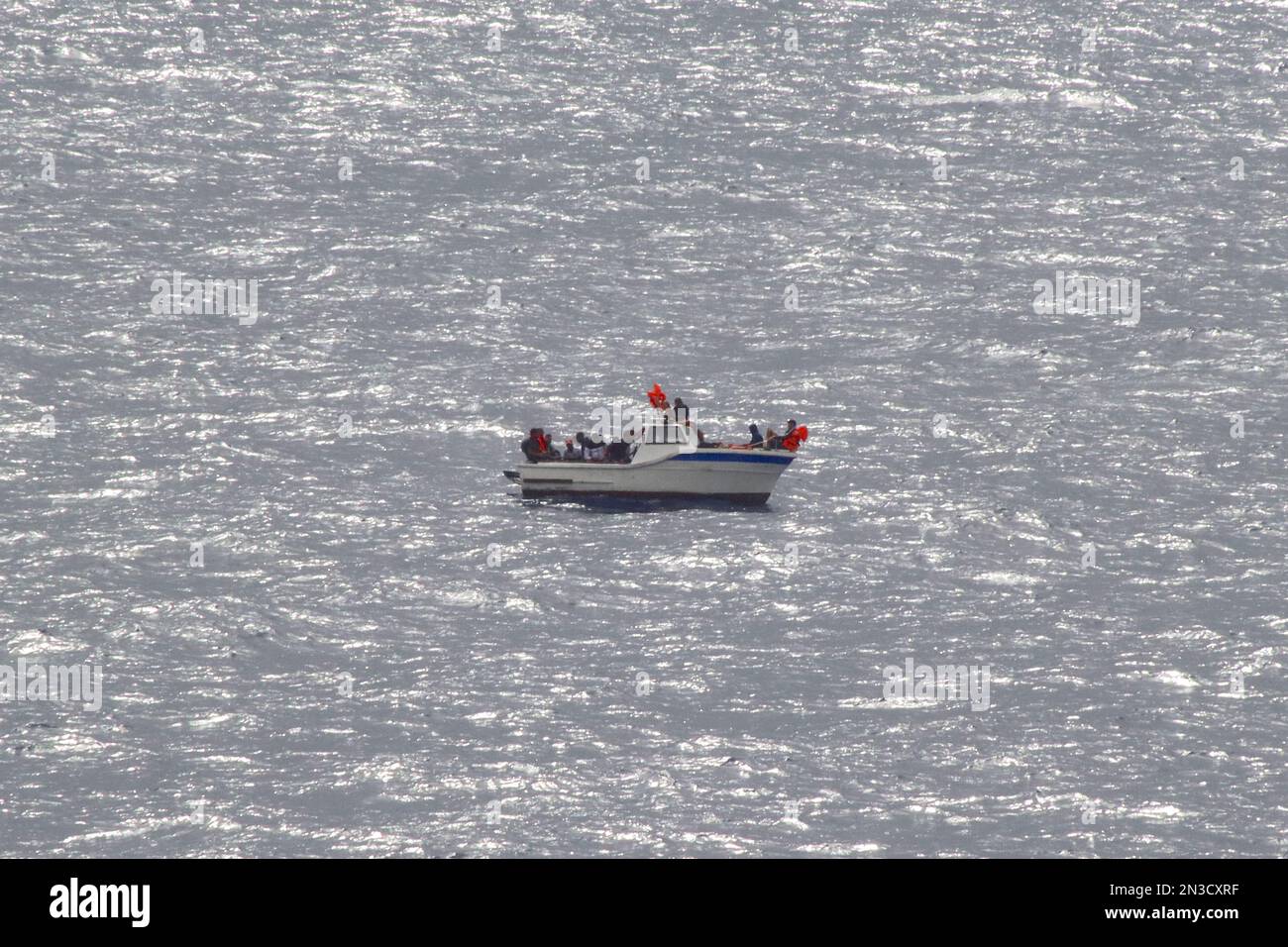 23 maschi algerini disidratati, maroonati avendo perso il potere sulla loro barca mentre si sposta nel Mar Mediterraneo, a 100 miglia da terra, agosto 2022. Foto Stock