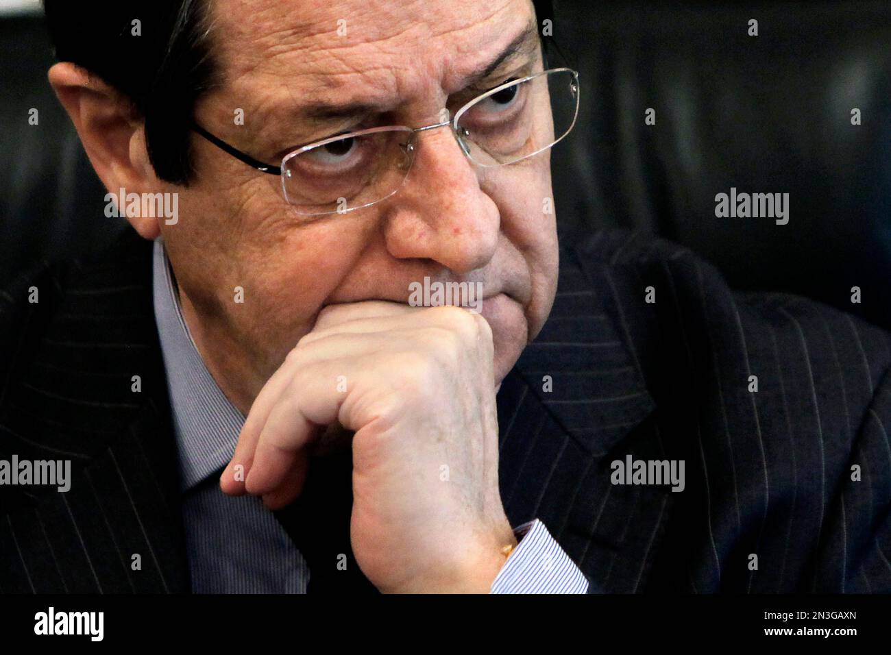FILE - Monday, Feb. 17, 2014 photo from files showing Cyprus' President Nicos Anastasiades listens during an interview with Associated Press at his office in the presidential palace in capital Nicosia, Cyprus. President Nicos Anastasiades will depart for New York on Saturday Nov. 29, 2014 and will undergo the surgery at a hospital there on Dec. 4, according to government spokesman Nicos Christodoulides. (AP Photo/Petros Karadjias, File) Foto Stock
