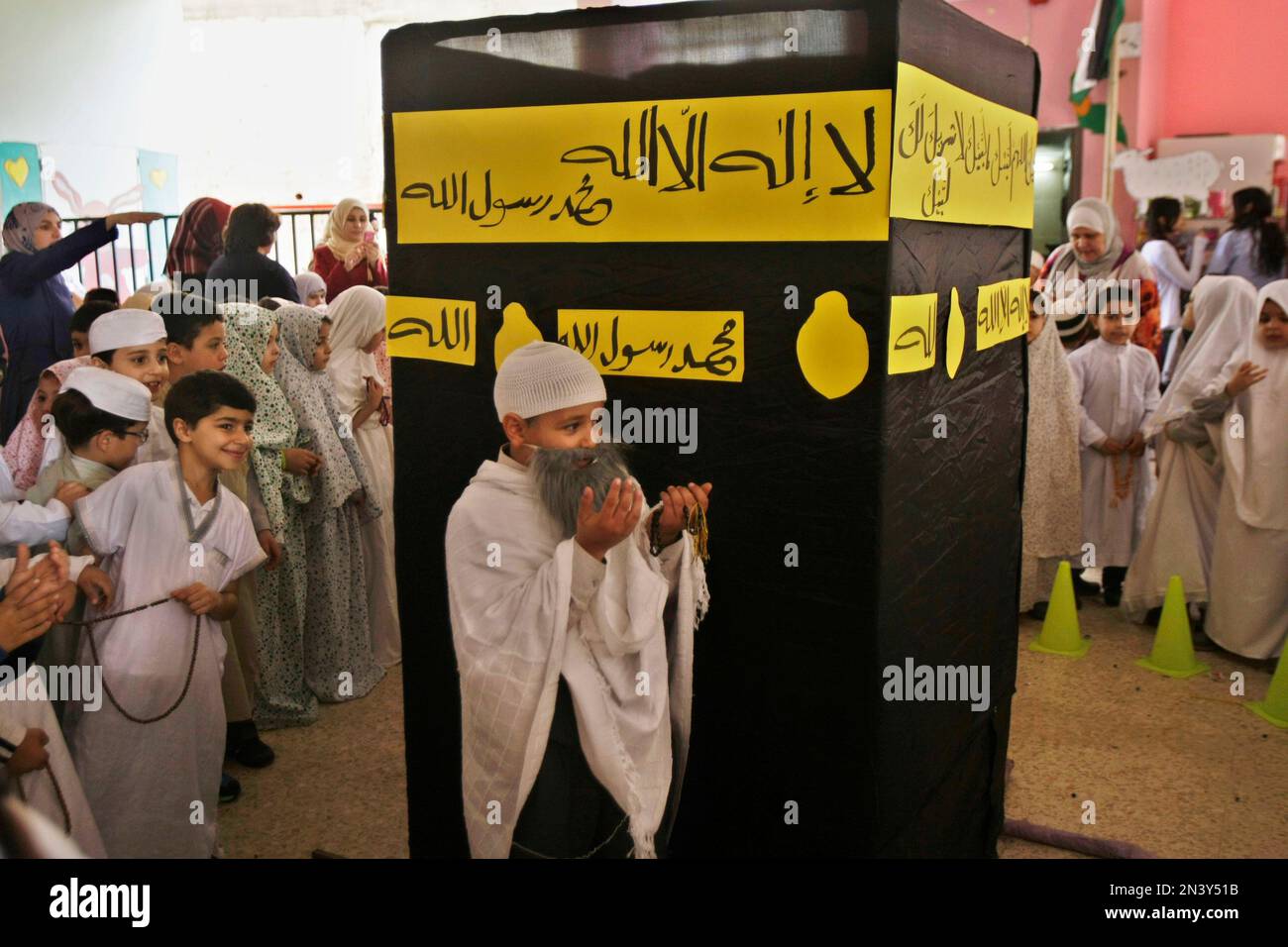 Palestinian Students Gather Around A Model That Represents The Kaaba In Palestinian Students Gather Around A Model That Represents The Kaaba In