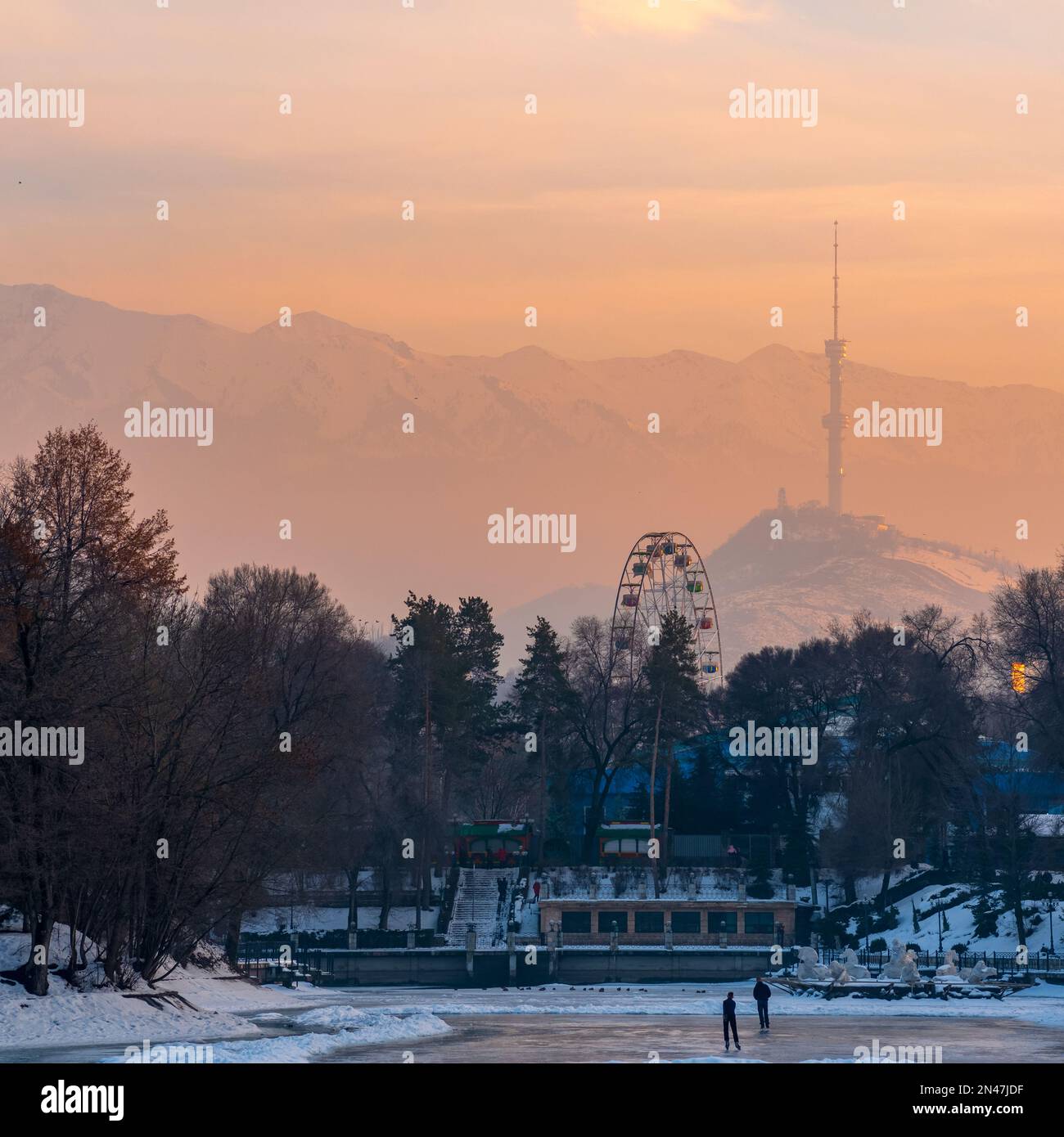 Almaty, Kazakhstan - 07 gennaio 2023: Tramonto invernale vista dal parco della città al monte Koktobe con torre televisiva Foto Stock