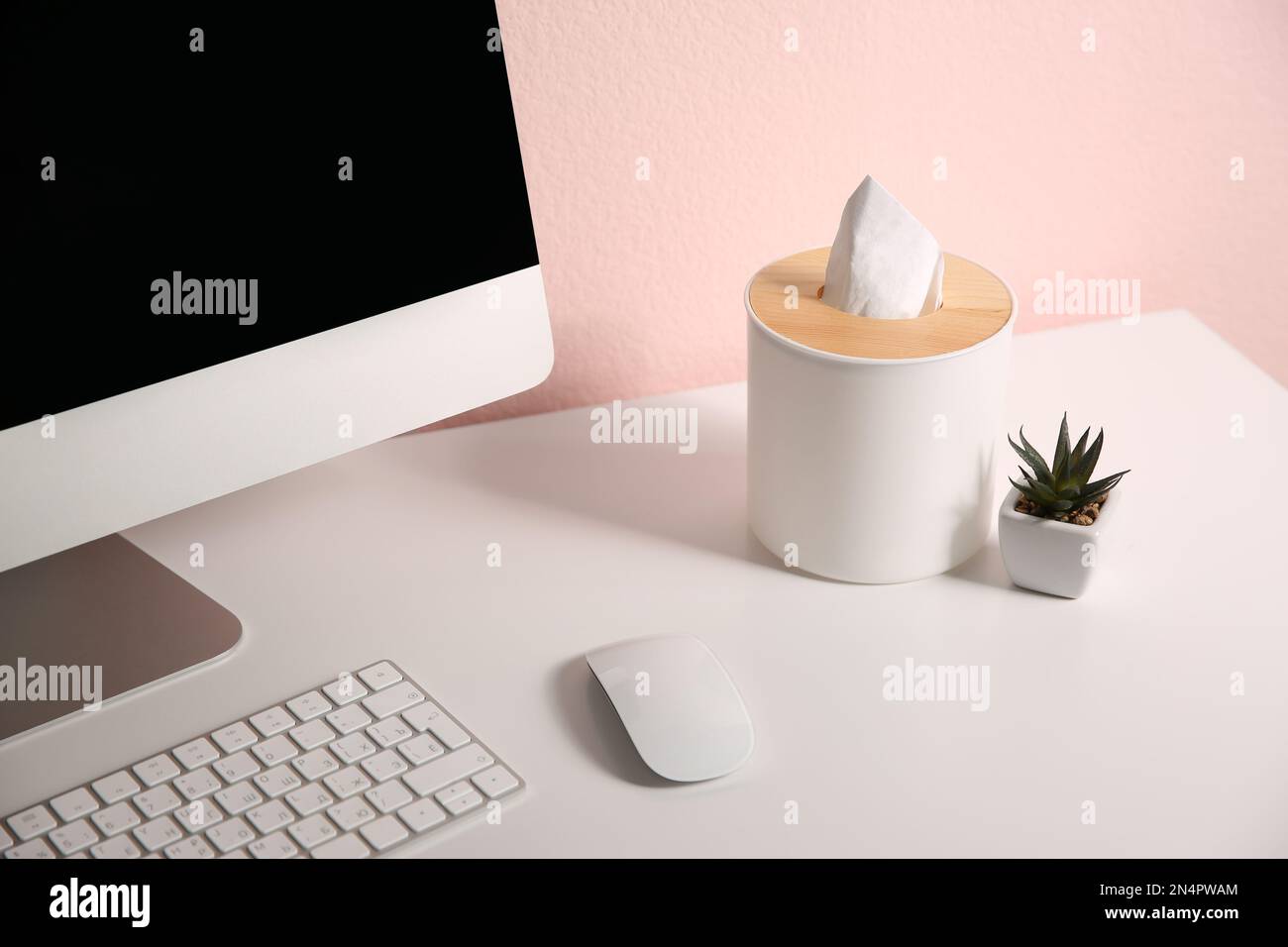 Scatola con fazzolettini di carta su tavolo bianco sul posto di lavoro Foto Stock