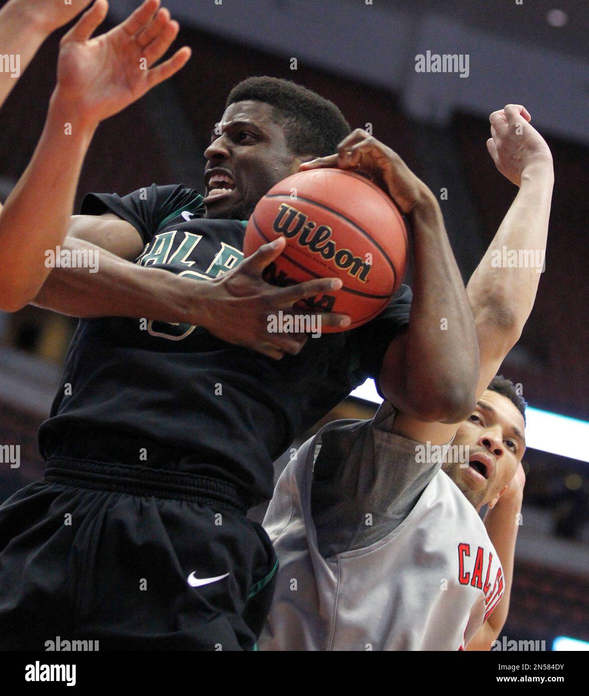 Cal Poly guard Dave Nwaba, left, pulls down a rebound against Cal State